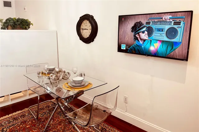 a view of a room with table and chairs