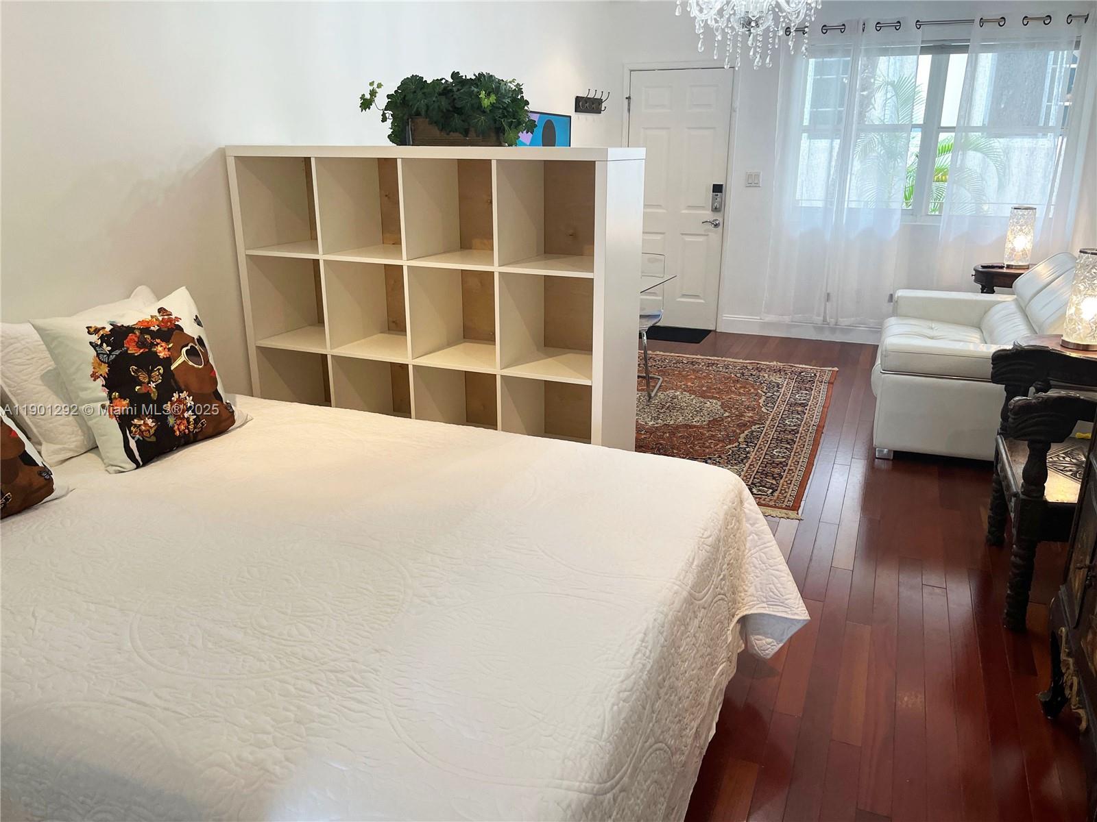 1340 Drexel Avenue, Unit 406 Miami Beach, FL 33139 - Photo 17 of 34 a large bed sitting in a bedroom next to a window