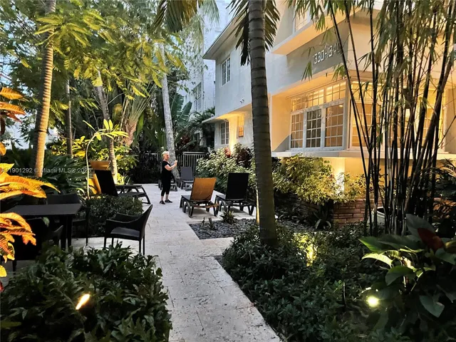 a view of a patio with table and chairs and potted plants