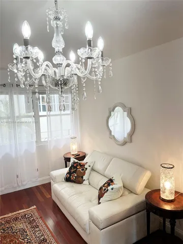 a view of a dining room with furniture and chandelier