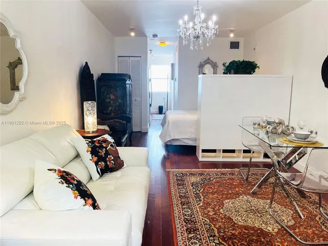 a bedroom with furniture and a chandelier