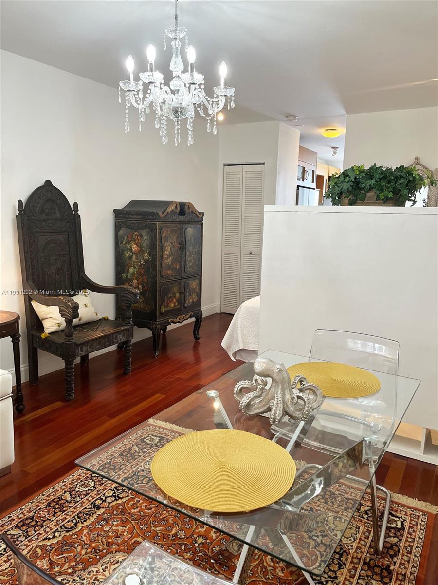 1340 Drexel Avenue, Unit 406 Miami Beach, FL 33139 - Photo 10 of 34 a living room with dining table and a couch