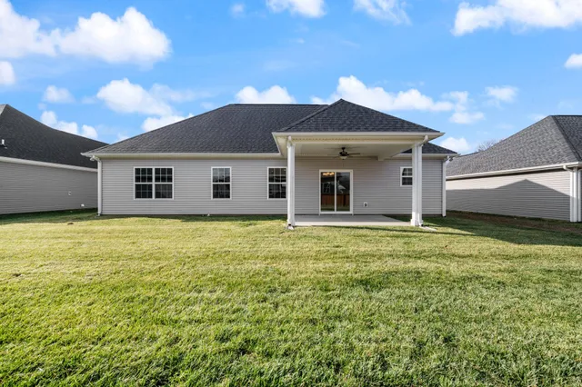 a view of a house with a backyard