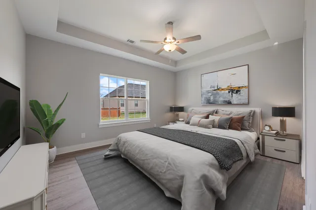 a bedroom with a large bed and a chandelier