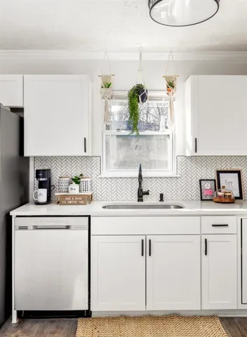 a kitchen with cabinets and white appliances