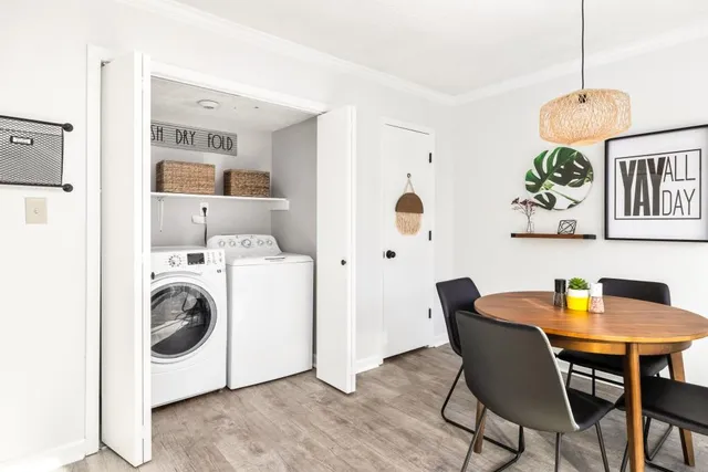 a view of a dining room with furniture and chandelier