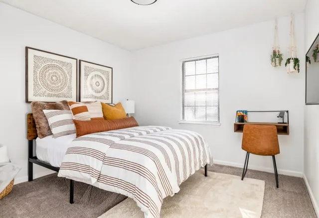 a bedroom with a bed and dresser