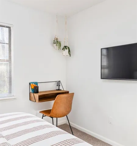 a bedroom with a bed and a chair