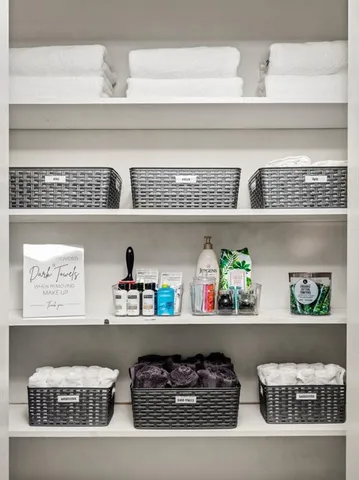 a view of white cabinets with lots of different wooden cabinets