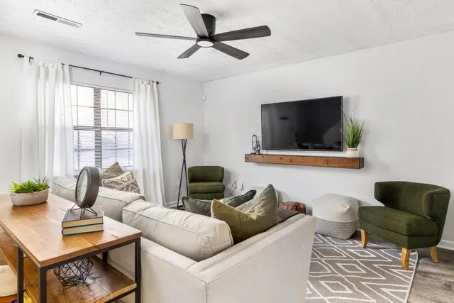 a living room with furniture and a flat screen tv