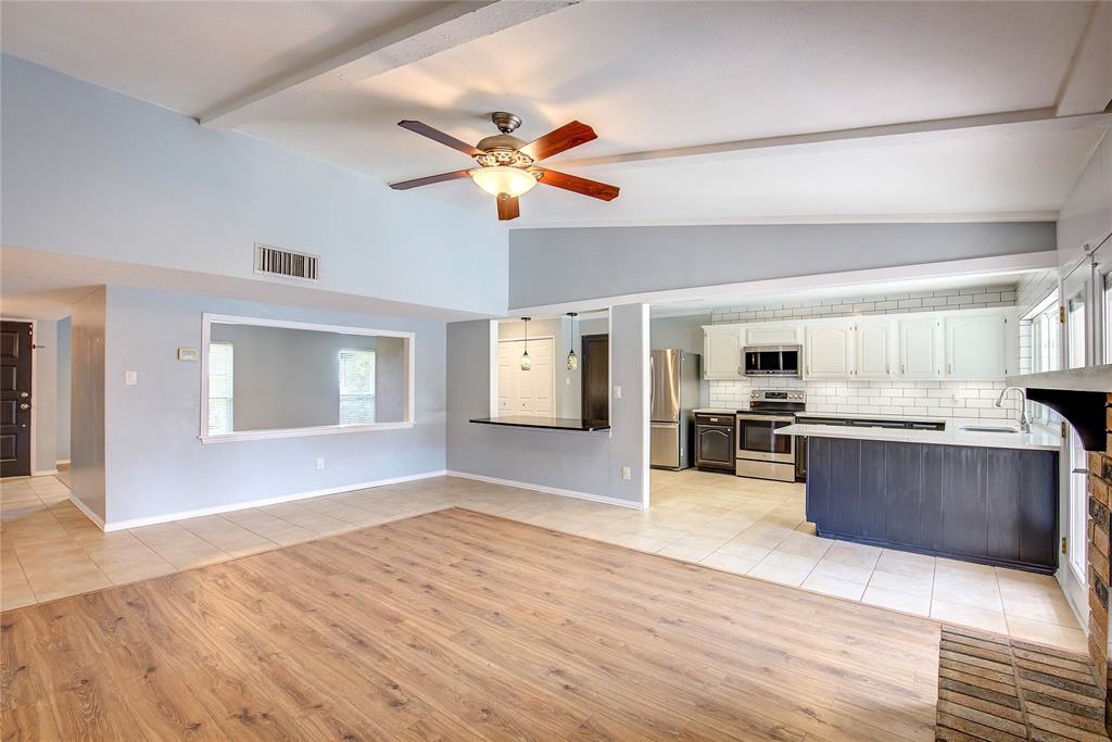 5233 Reed Drive The Colony, TX 75056 - Photo 14 of 40 a view of a kitchen with kitchen island a counter top space appliances and cabinets