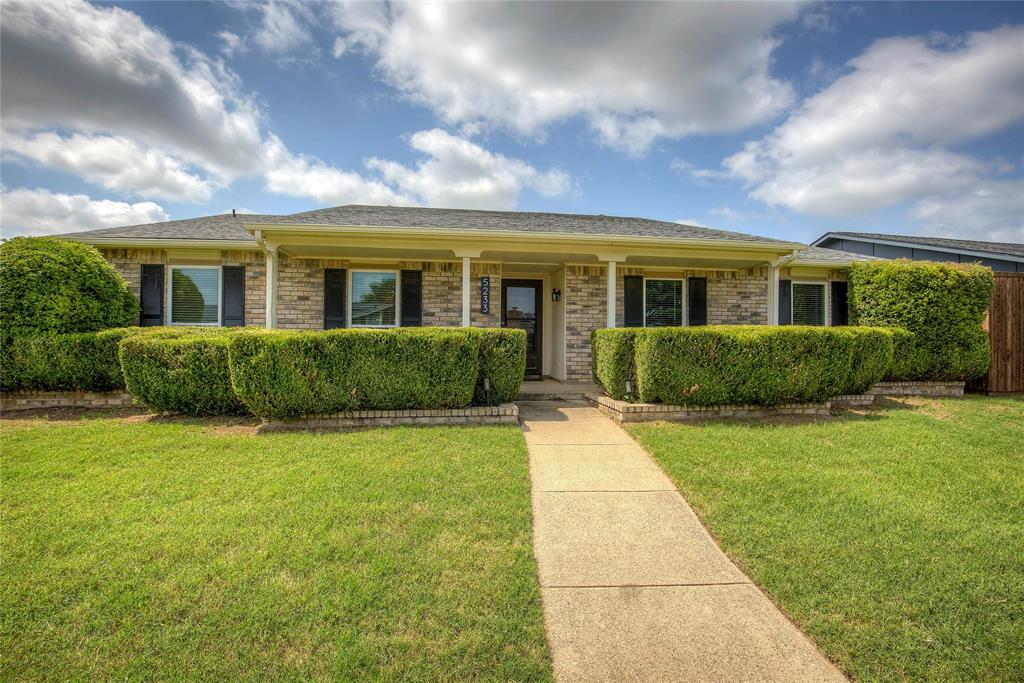 5233 Reed Drive The Colony, TX 75056 - Photo 2 of 40 a front view of a house with a yard