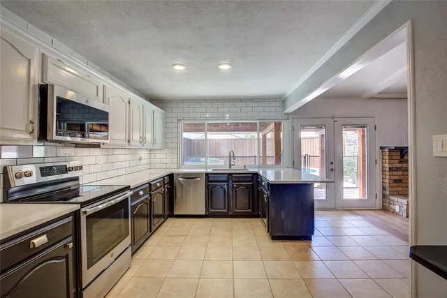 a kitchen with a stove sink and microwave