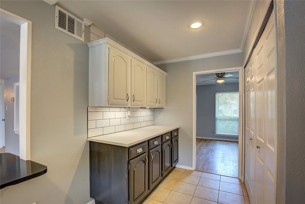 5233 Reed Drive The Colony, TX 75056 - Photo 26 of 40 a kitchen with stainless steel appliances granite countertop a sink and cabinets