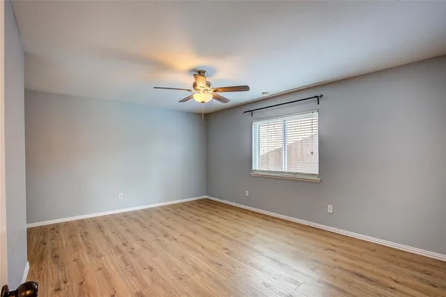 a view of a room with a window and wooden floor