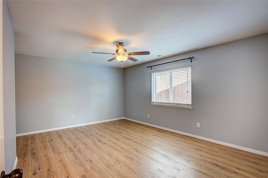 5233 Reed Drive The Colony, TX 75056 - Photo 27 of 40 a view of a room with a window and wooden floor