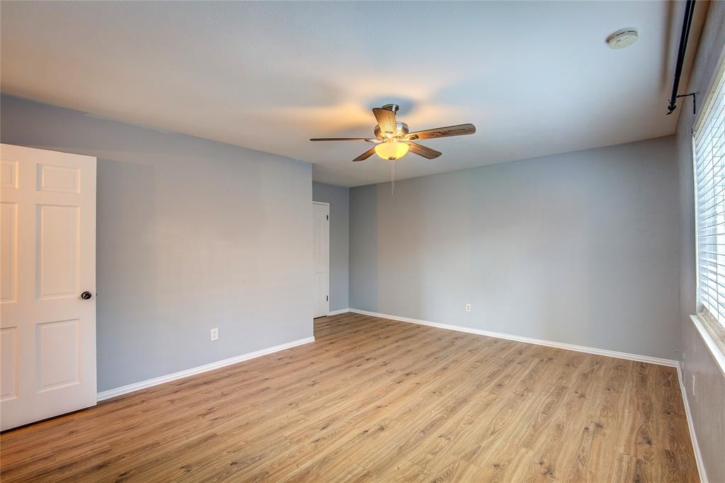 5233 Reed Drive The Colony, TX 75056 - Photo 28 of 40 a view of an empty room and window with wooden floor