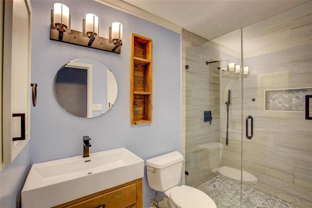 5233 Reed Drive The Colony, TX 75056 - Photo 30 of 40 a bathroom with a toilet sink and shower