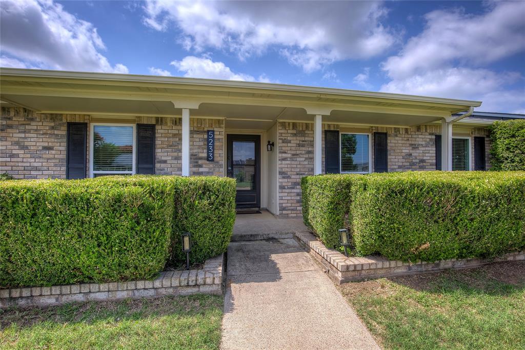 5233 Reed Drive The Colony, TX 75056 - Photo 3 of 40 a view of a house with large windows and a flower plants