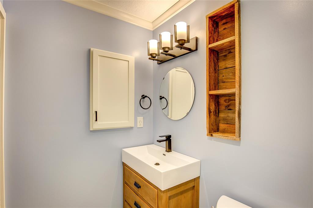5233 Reed Drive The Colony, TX 75056 - Photo 31 of 40 a bathroom with a sink and a mirror