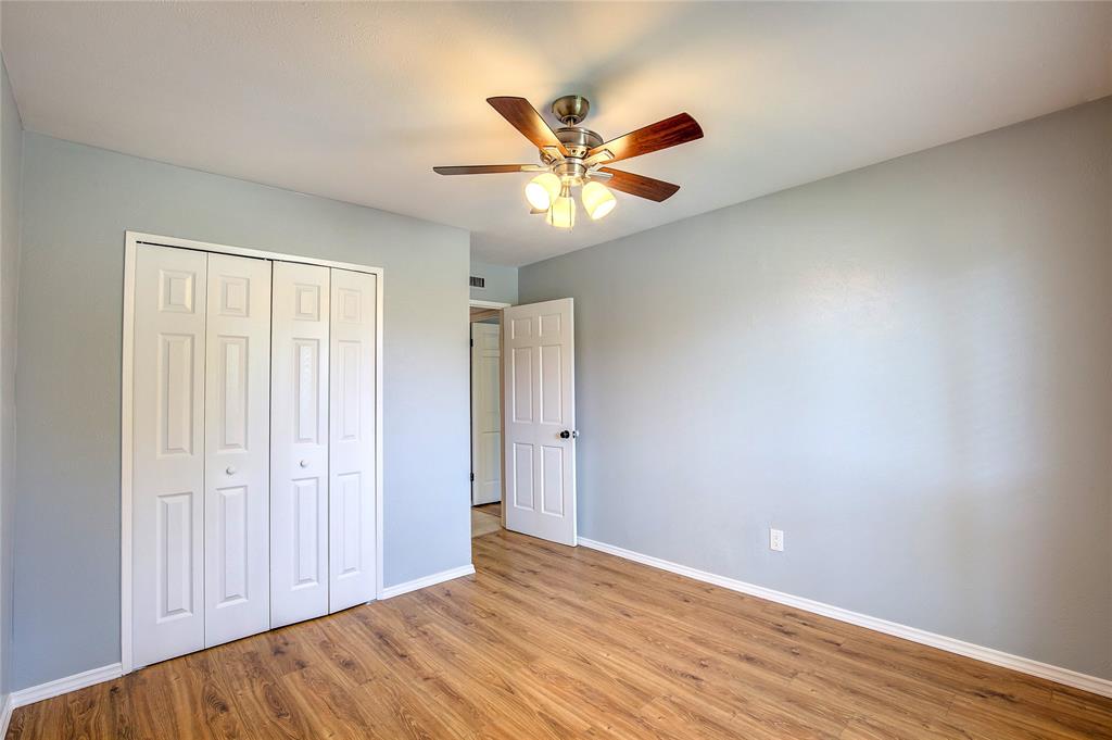 5233 Reed Drive The Colony, TX 75056 - Photo 34 of 40 wooden floor in an empty room with a window