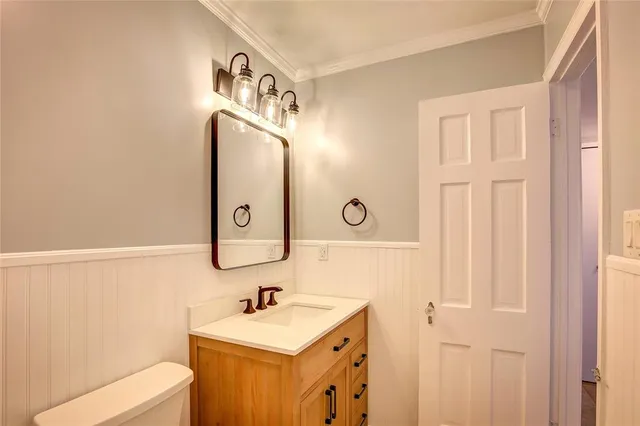 a bathroom with a sink a mirror and a toilet