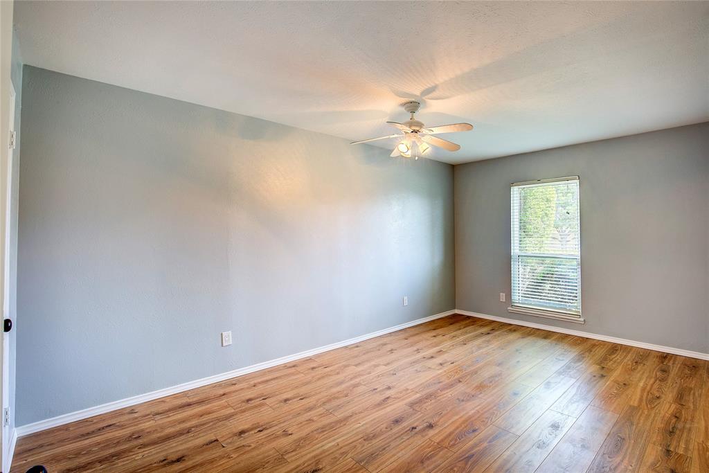 5233 Reed Drive The Colony, TX 75056 - Photo 38 of 40 an empty room with wooden floor and windows