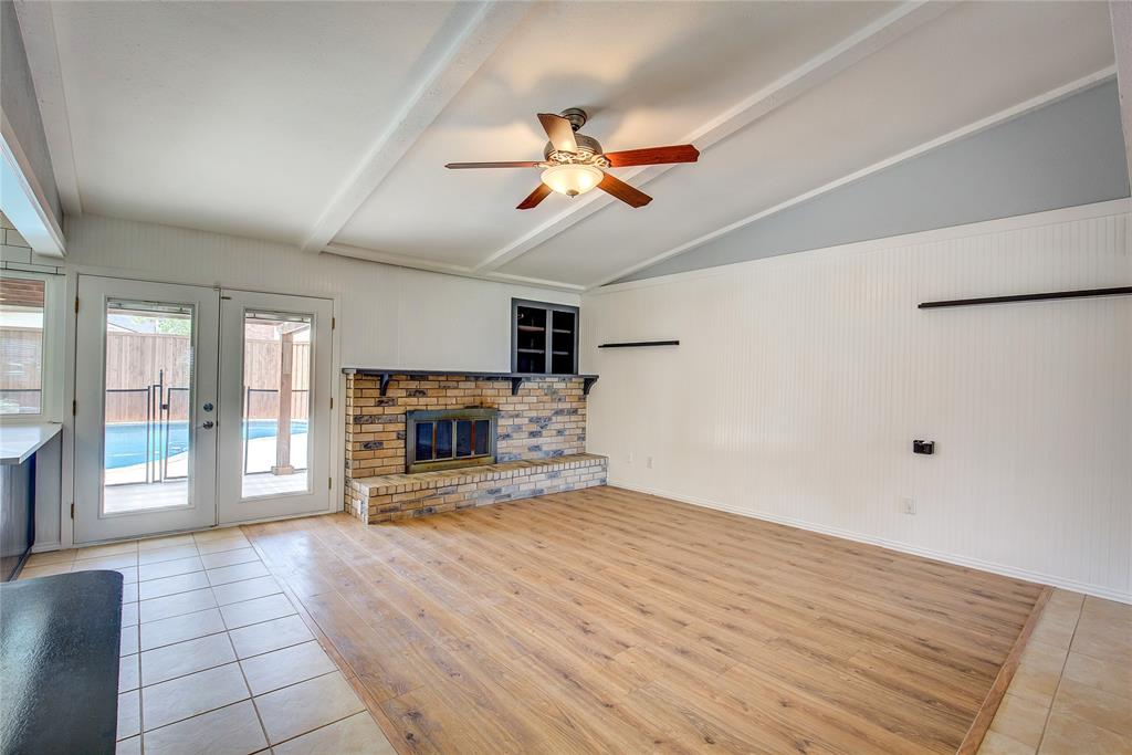 5233 Reed Drive The Colony, TX 75056 - Photo 9 of 40 an empty room with windows and fireplace