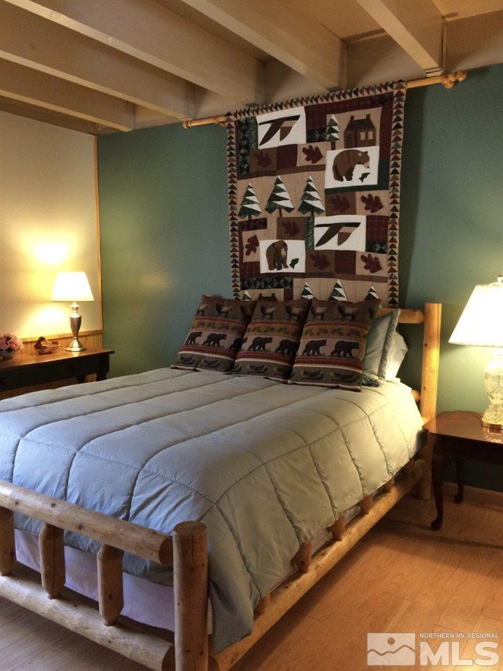 233 Clubhouse Circle Stateline, NV 89449 - Photo 11 of 28 a bedroom with a bed and a lamp