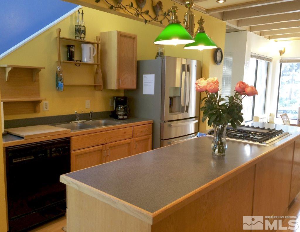 233 Clubhouse Circle Stateline, NV 89449 - Photo 18 of 28 a kitchen with stainless steel appliances granite countertop a sink a stove and a refrigerator