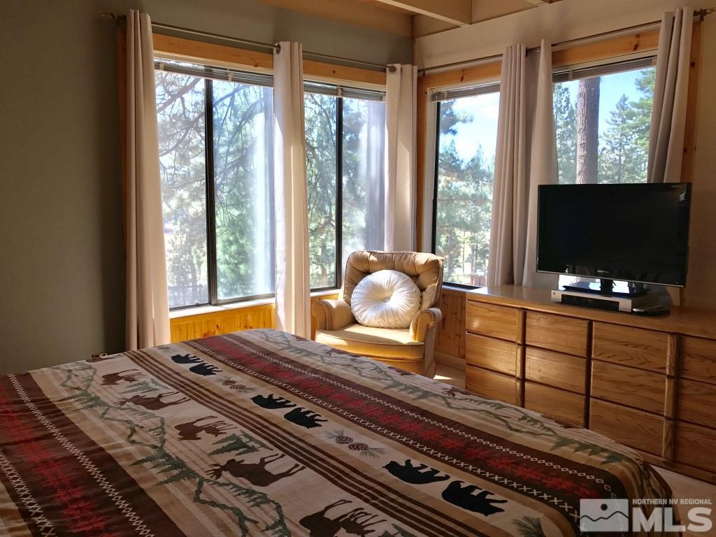 233 Clubhouse Circle Stateline, NV 89449 - Photo 7 of 28 a bedroom with bed and flat screen tv