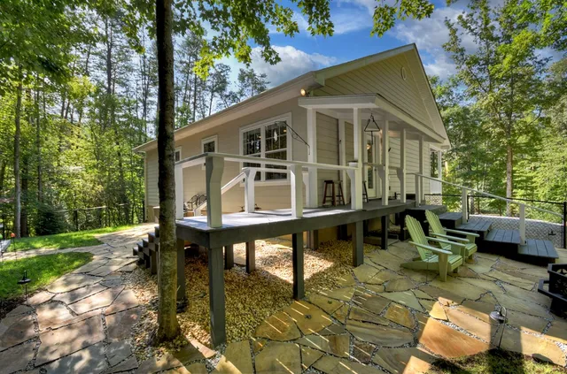 a backyard of a house with yard and outdoor seating