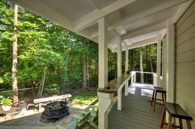 a view of a porch with furniture and wooden floor