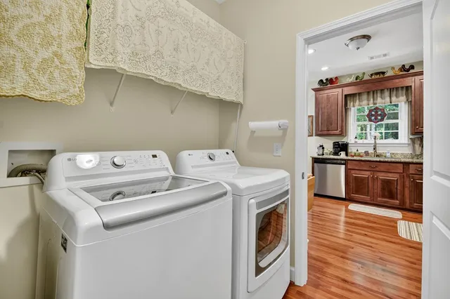 a utility room with dryer washer and a sink