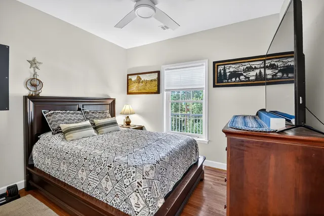 a bedroom with a bed and glass window