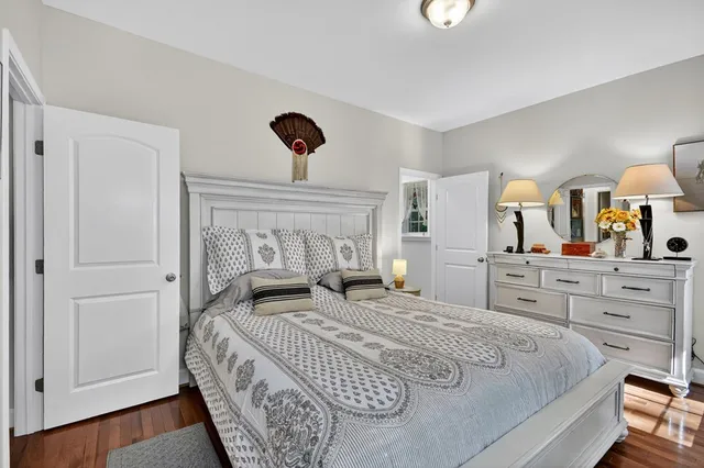 a bedroom with a large bed and a dresser