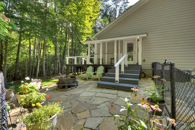 a view of a house with backyard sitting area and garden
