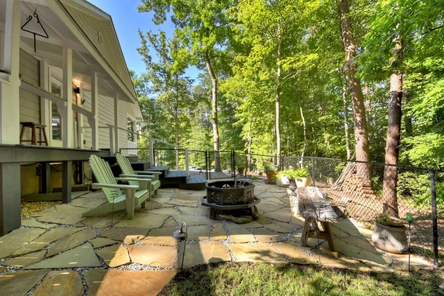 a view of a patio with couches table and chairs and potted plants