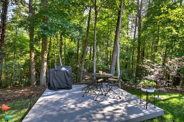 a view of patio with table and chairs and potted plants