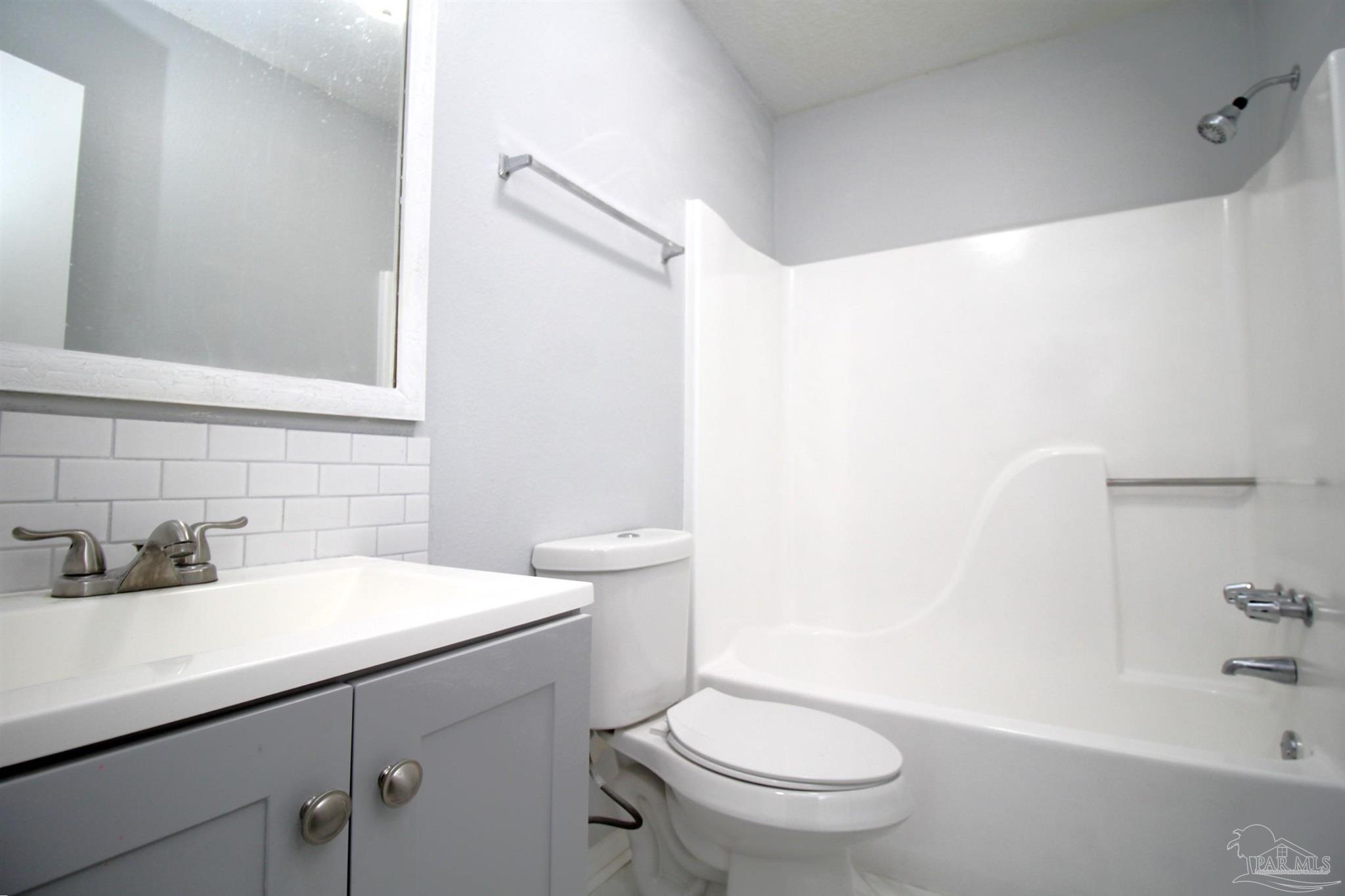 7116 Pearson Road, Unit C Pensacola, FL 32526 - Photo 20 of 20 a bathroom with a sink a toilet and shower