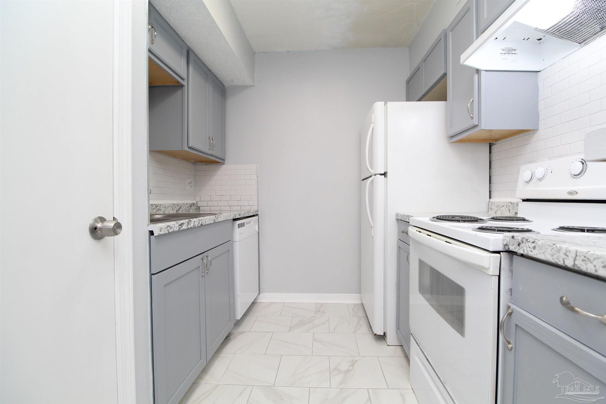 7116 Pearson Road, Unit C Pensacola, FL 32526 - Photo 8 of 20 a kitchen with stainless steel appliances granite countertop a refrigerator and a stove