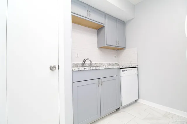 a kitchen with white cabinets and white appliances