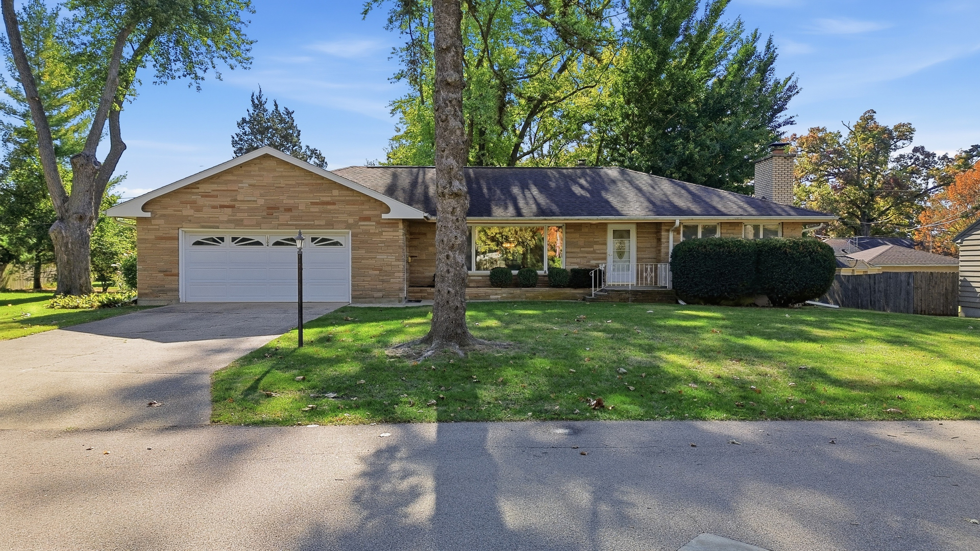 a front view of a house with a garden and yard