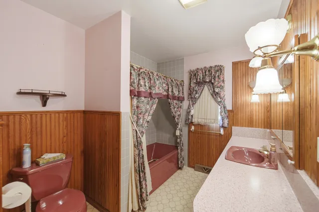 a bathroom with a granite countertop sink a mirror and a shower