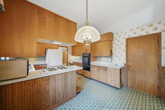 a kitchen with a sink a stove and refrigerator