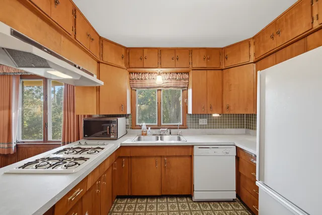 a big room with a bed and a dresser