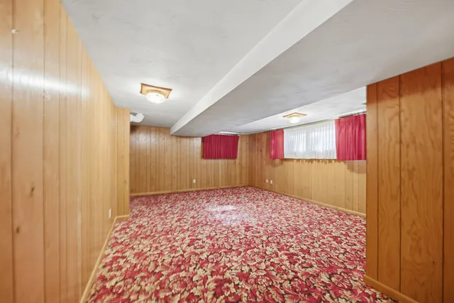 a bathroom with a granite countertop toilet sink and mirror