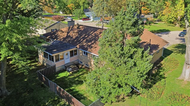 an aerial view of a house with a yard