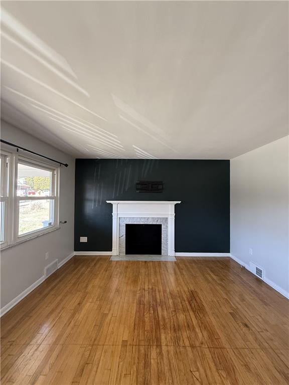 1681 Robbins Station Road Irwin, PA 15642 - Photo 11 of 27 a view of empty room with wooden floor and fireplace