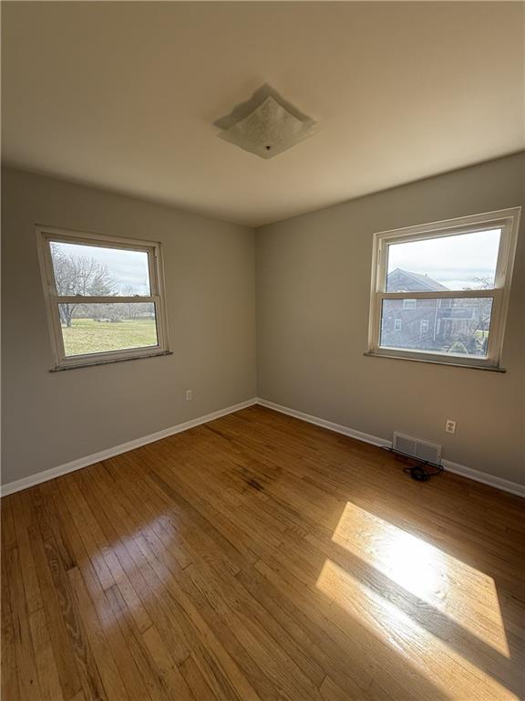 1681 Robbins Station Road Irwin, PA 15642 - Photo 20 of 27 a view of an empty room with wooden floor and a window